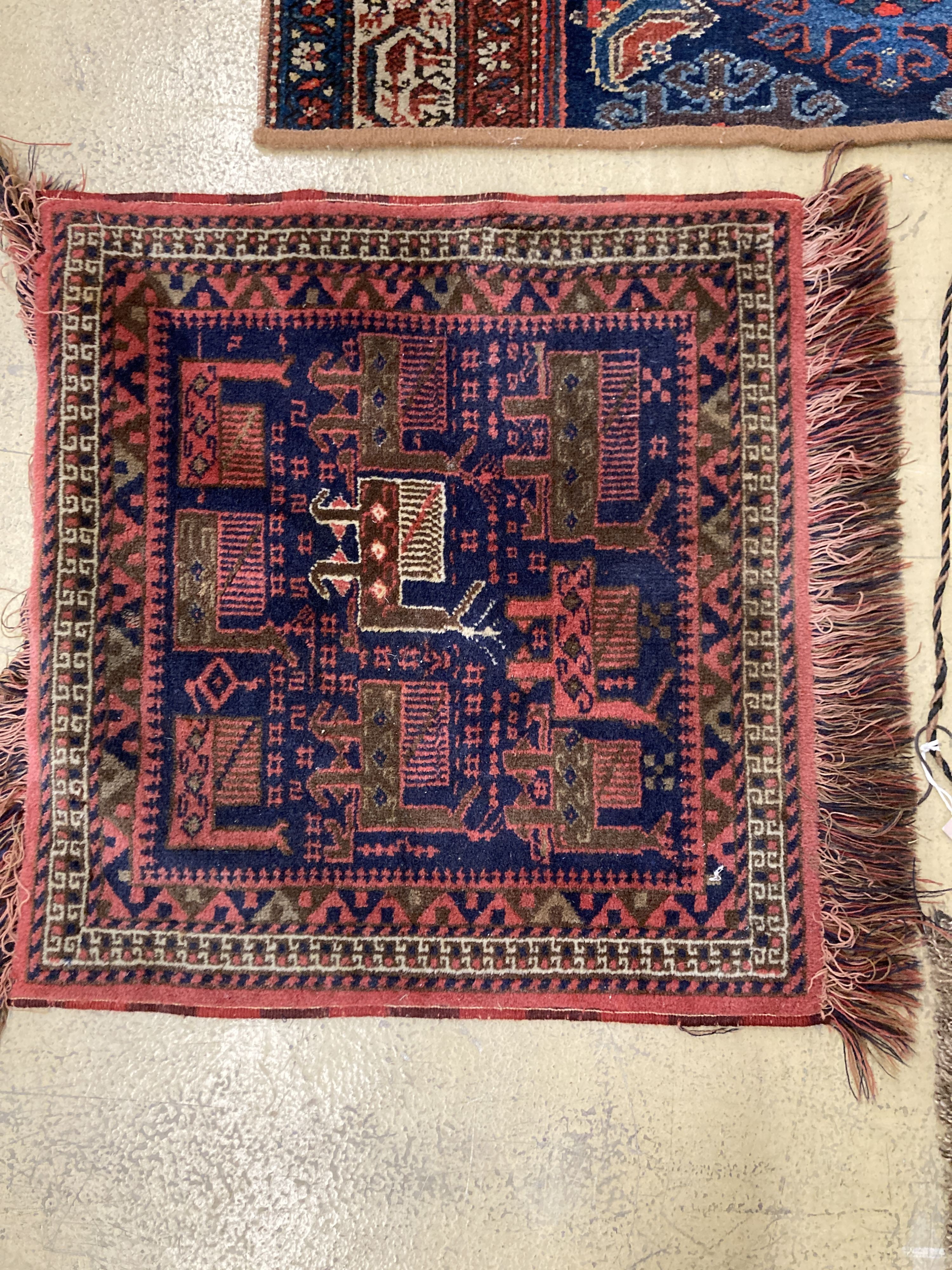 A Caucasian saddle bag and three mats, largest 100 x 40cm